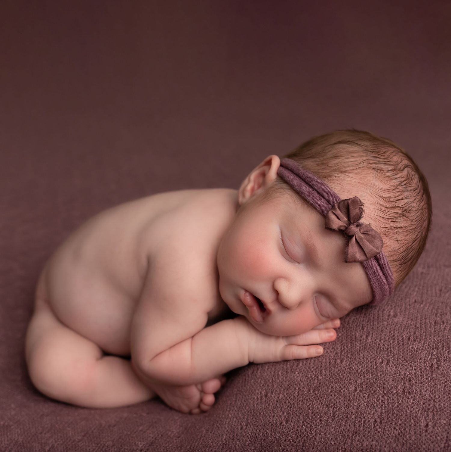 Newborn in purple, taken by Jen Knightstep, Photographer