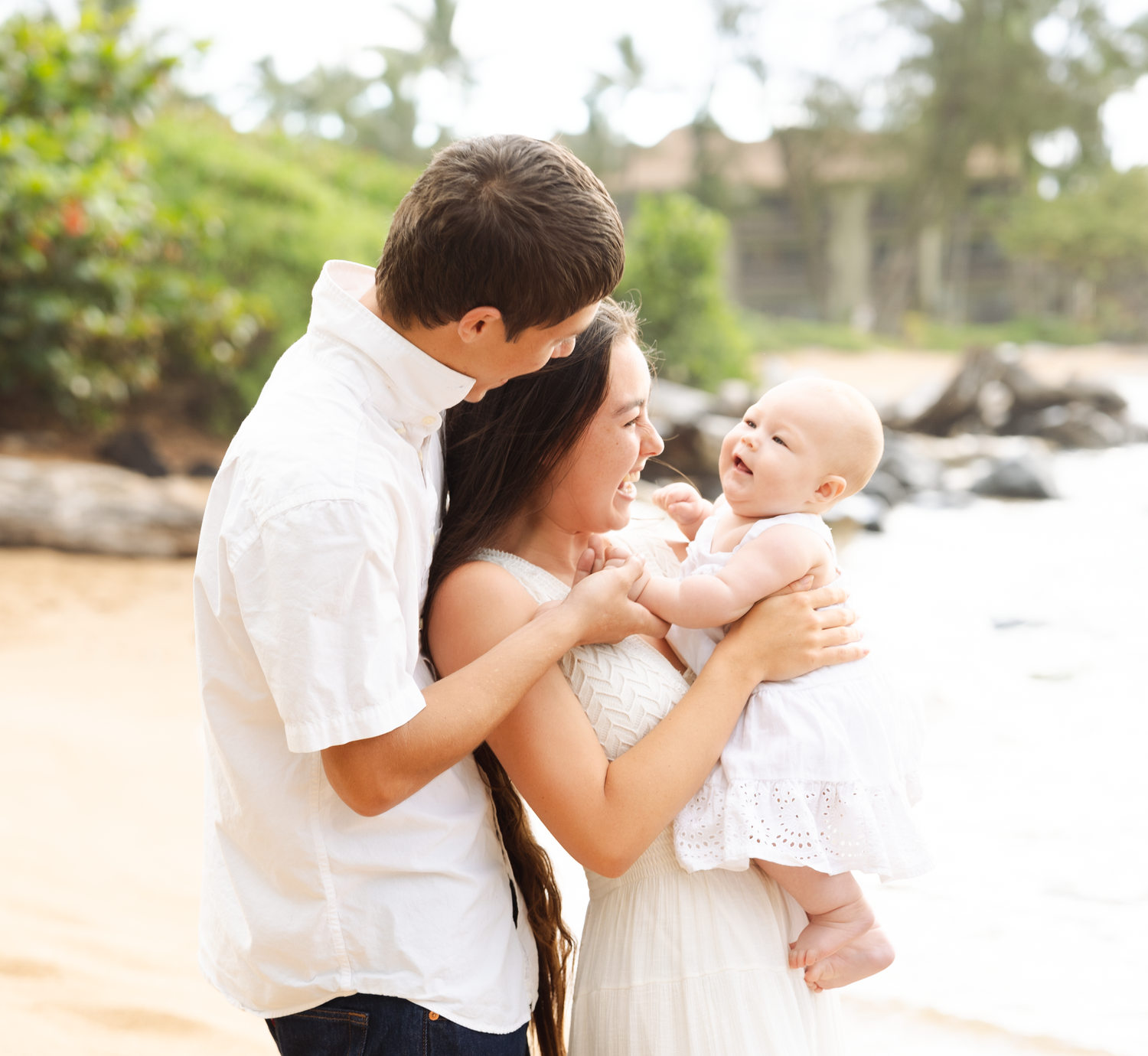 cute family sharing intimate moments with their preciosue little baby on a beach in kauai