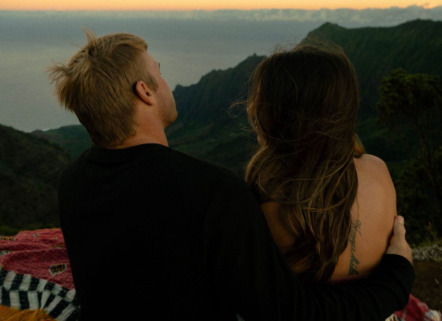 a couple in the mornig  over-looking the kalalau valley in koke'e