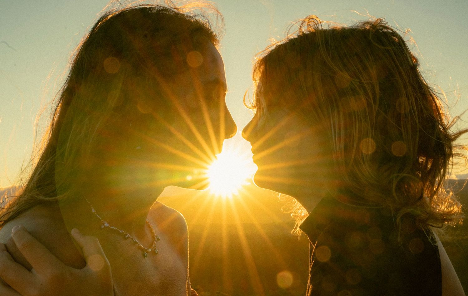 daughter and mother sharing the breathtaking experience of the sunrise from the mountain tops of koke'e