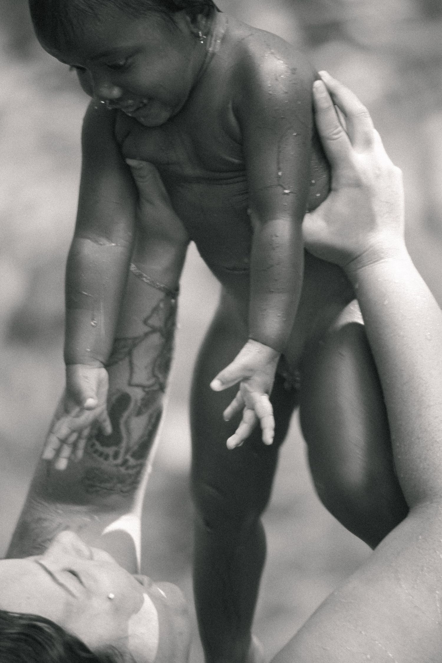 mother and daughter playing in the mountain near a river in Hawaii