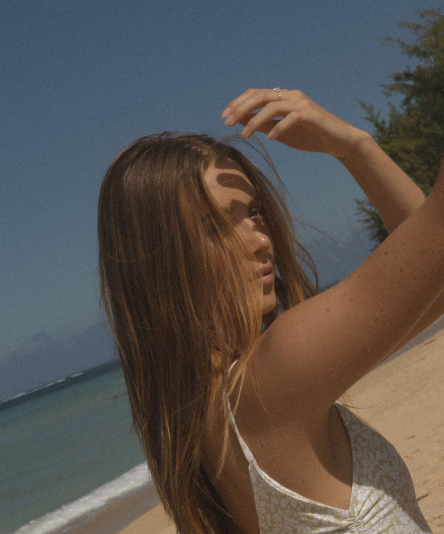beautiful light in Hawaii adds so much composition to the girl waiting for a wave to pass by