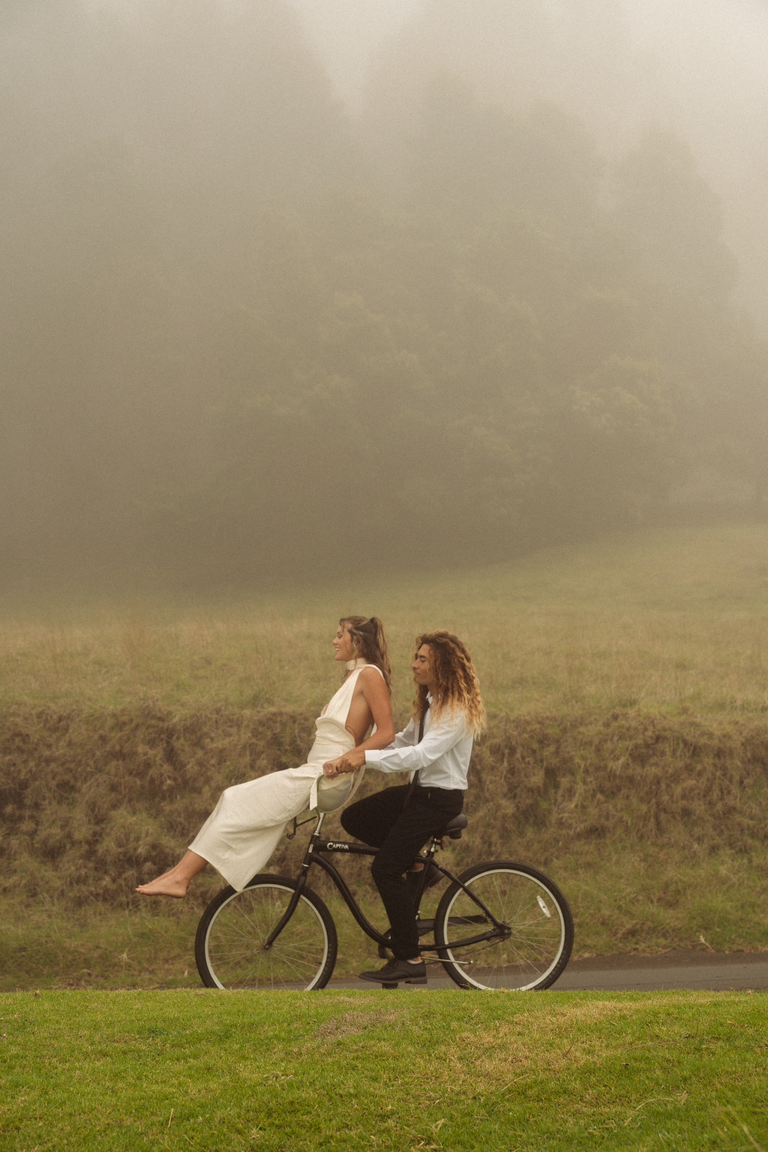 a couple on there elopement in Hawaii riding bikes