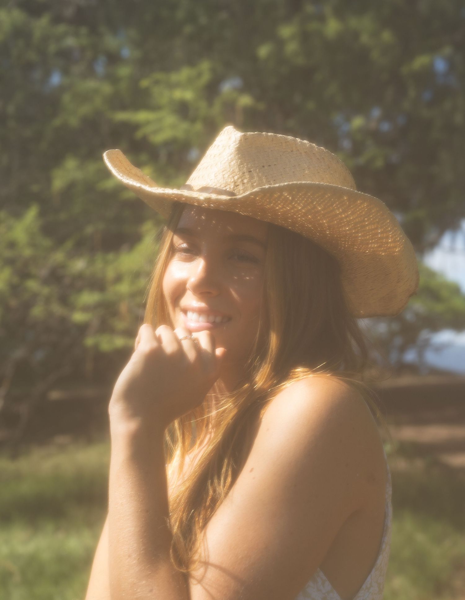 cowgirl on the beach in Hawaii with a smile shining miles