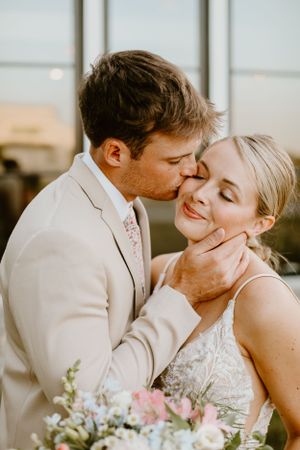 Intimate moment between couple during golden hour wedding portraits.