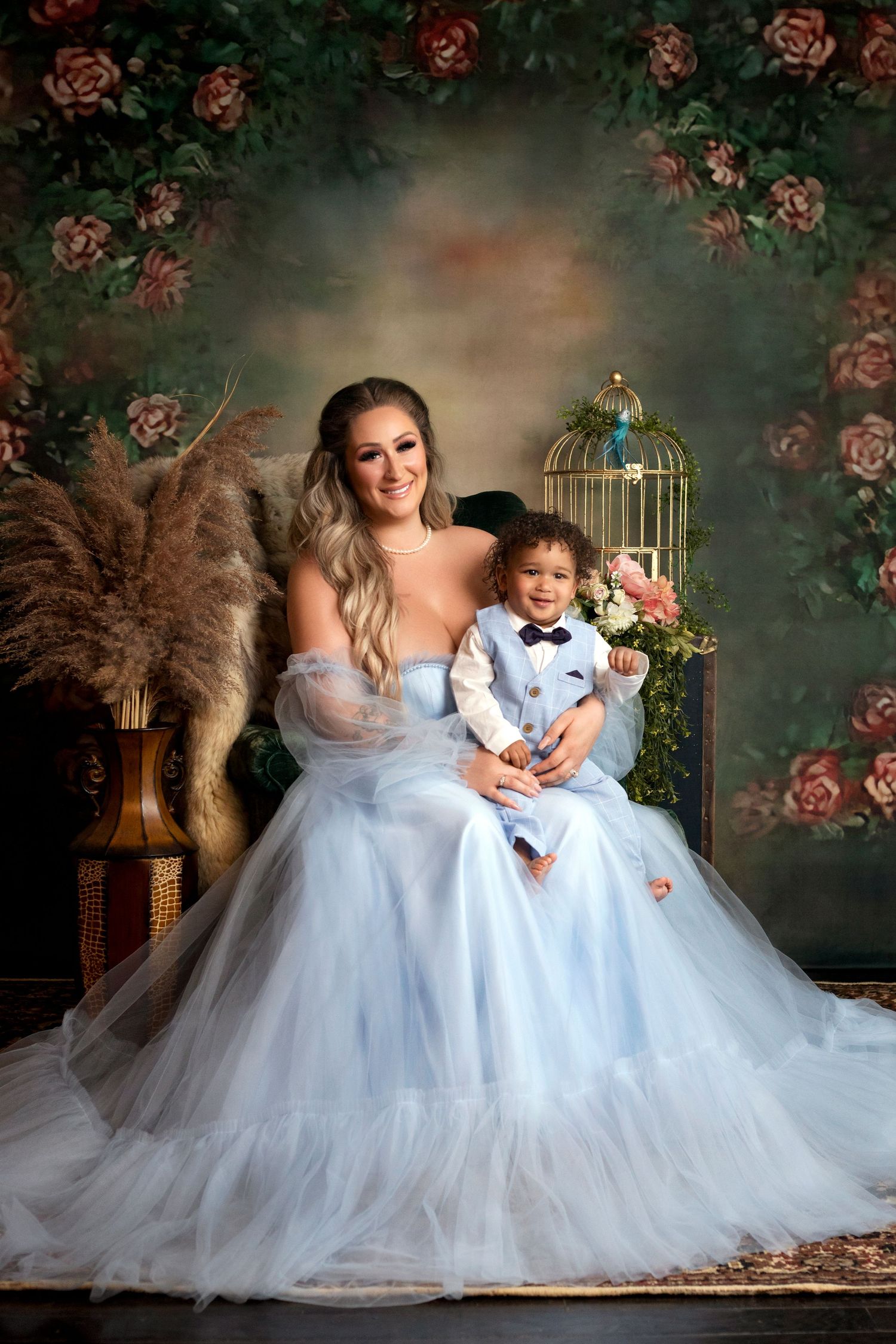 A dreamy portrait featuring flowing blue tulle dresses against a floral backdrop with roses.