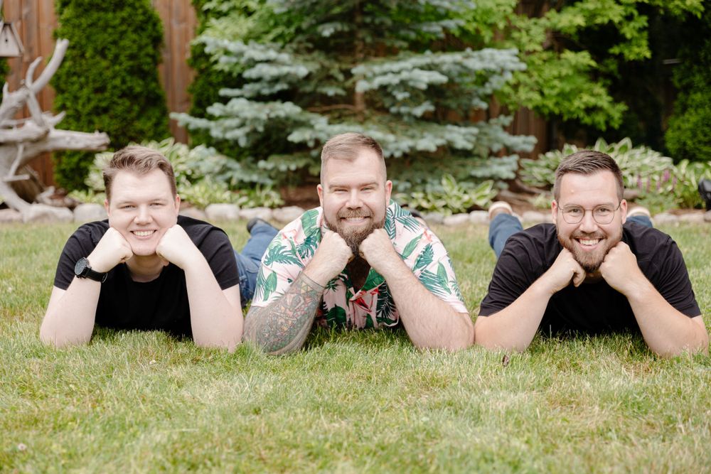 A group of men lying in grass.
