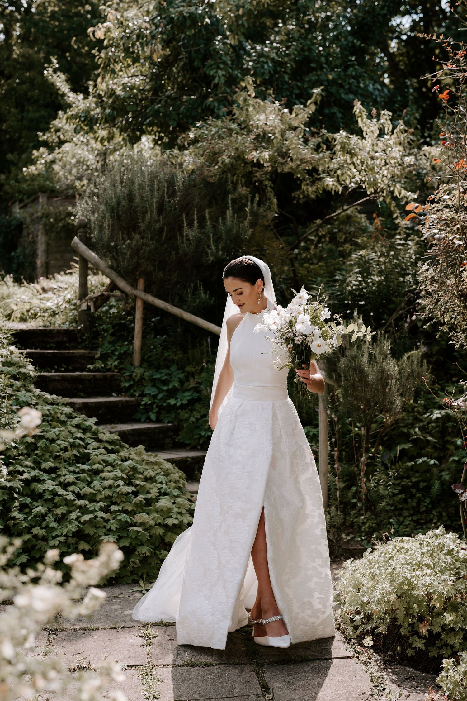 bride elegantly walking in gardens before her ceremony in Oxfordshire