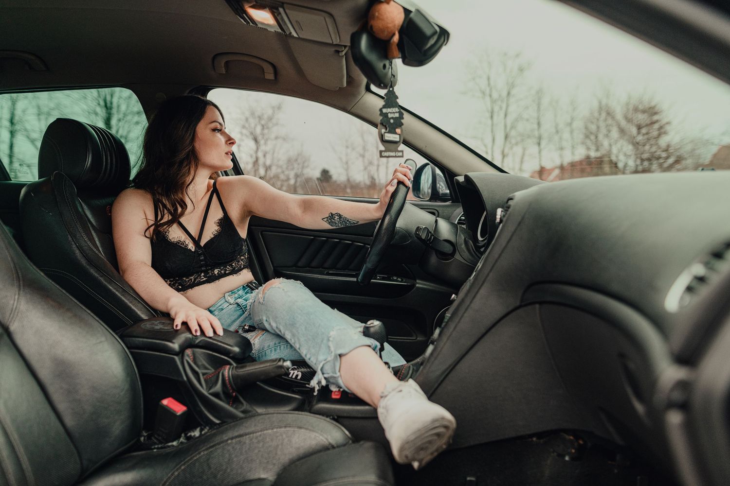 Person sitting in driver's seat of car shown from multiple angles.