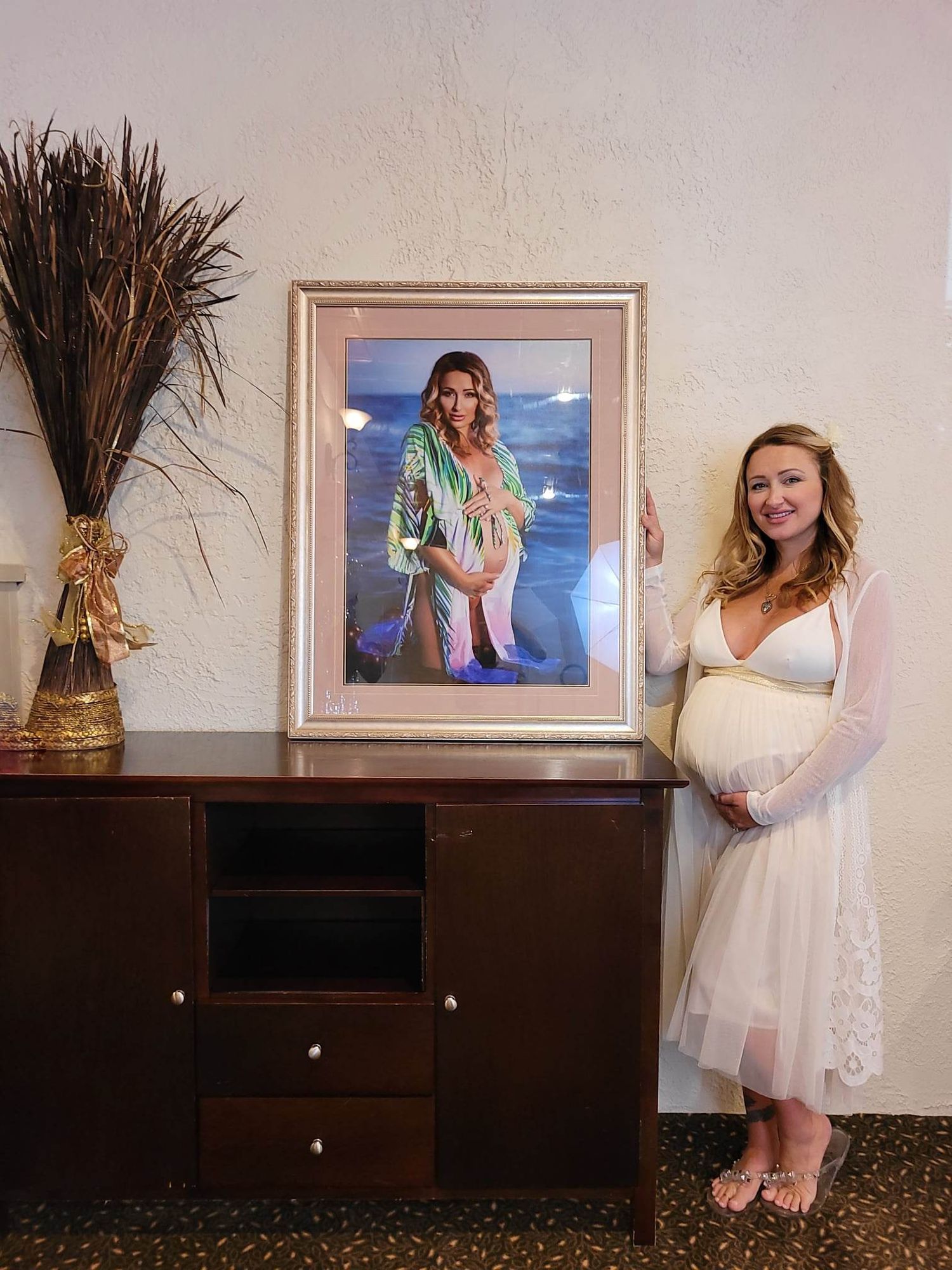 Maternity photo session display with framed beach portrait and decorative elements.