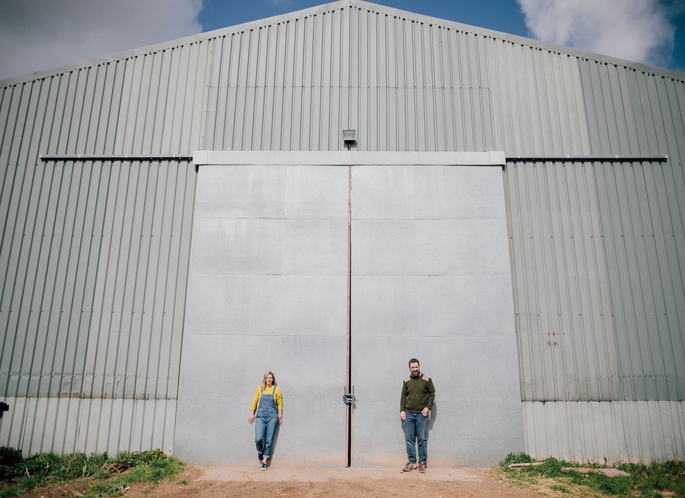 Creative sequence of couple walking and posing against industrial white warehouse wall. Worcestershire Wedding photographer.