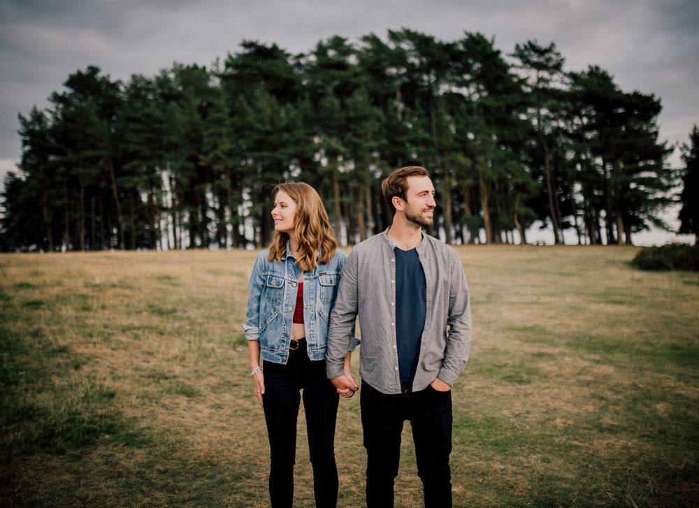 Couple's legs standing together in an outdoor field with pine trees in background. Worcestershire Wedding photographer.
