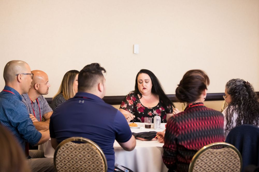Attendees participate in roundtable discussion during professional conference session.