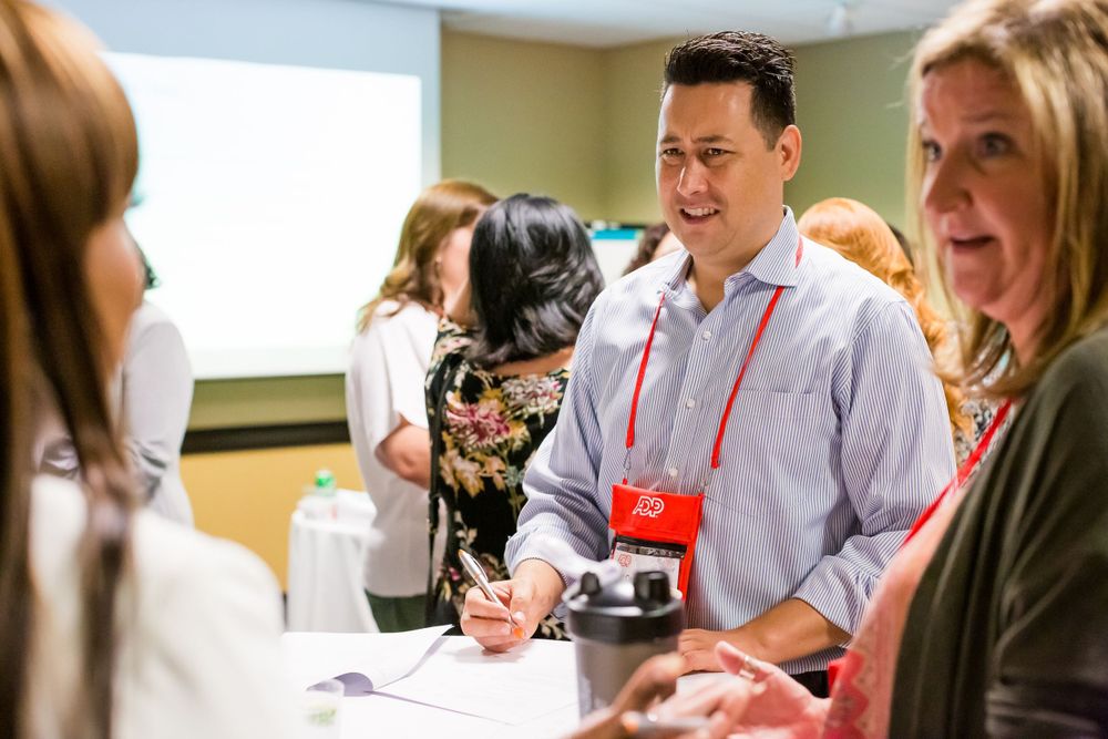 Conference attendees network and engage in conversation during a professional event.
