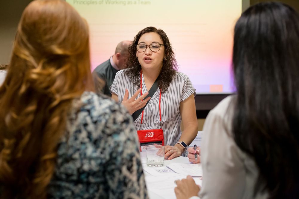 Conference participants engage in focused discussion during breakout session.