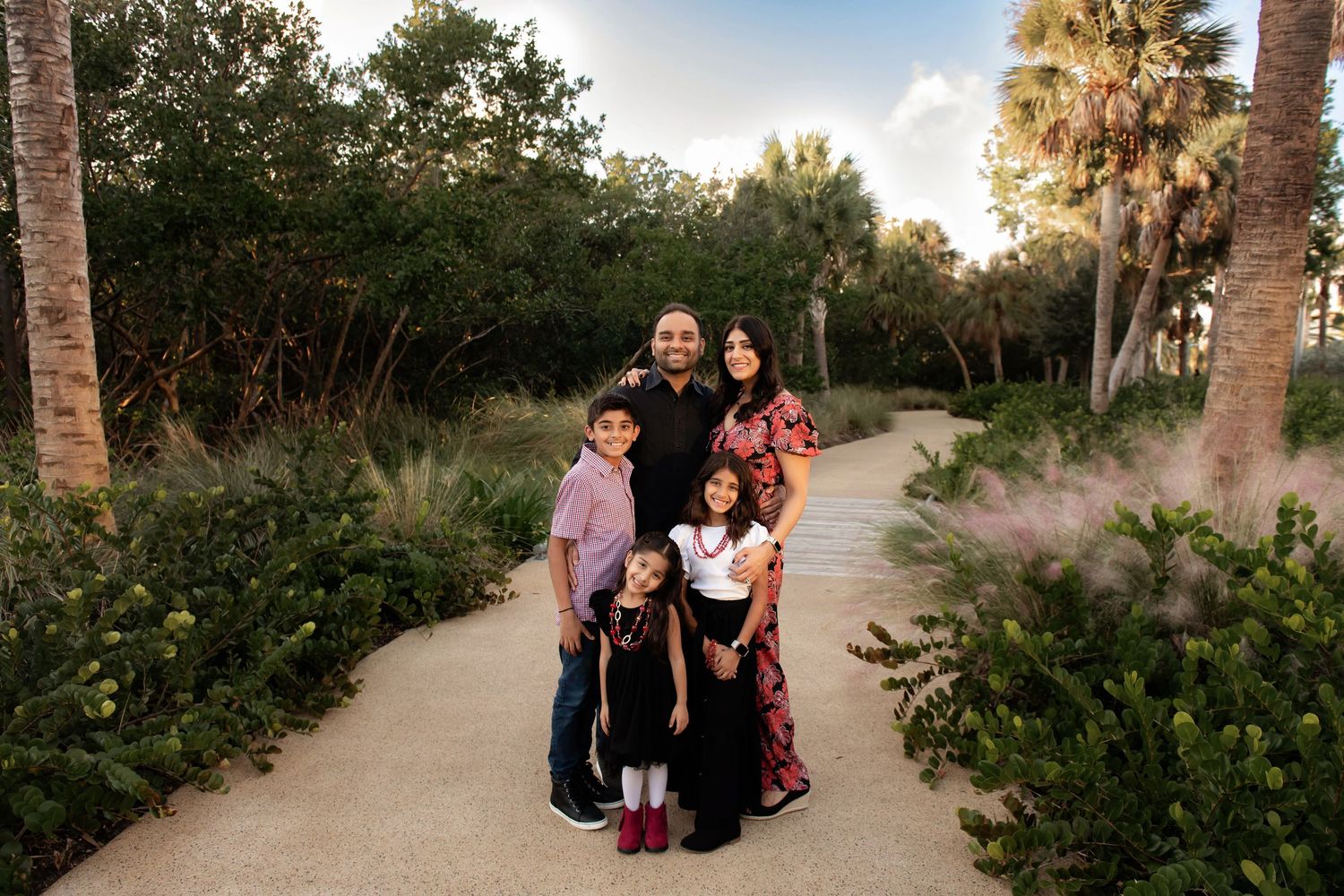 Palm trees line a scenic pathway at golden hour creating a peaceful outdoor setting.