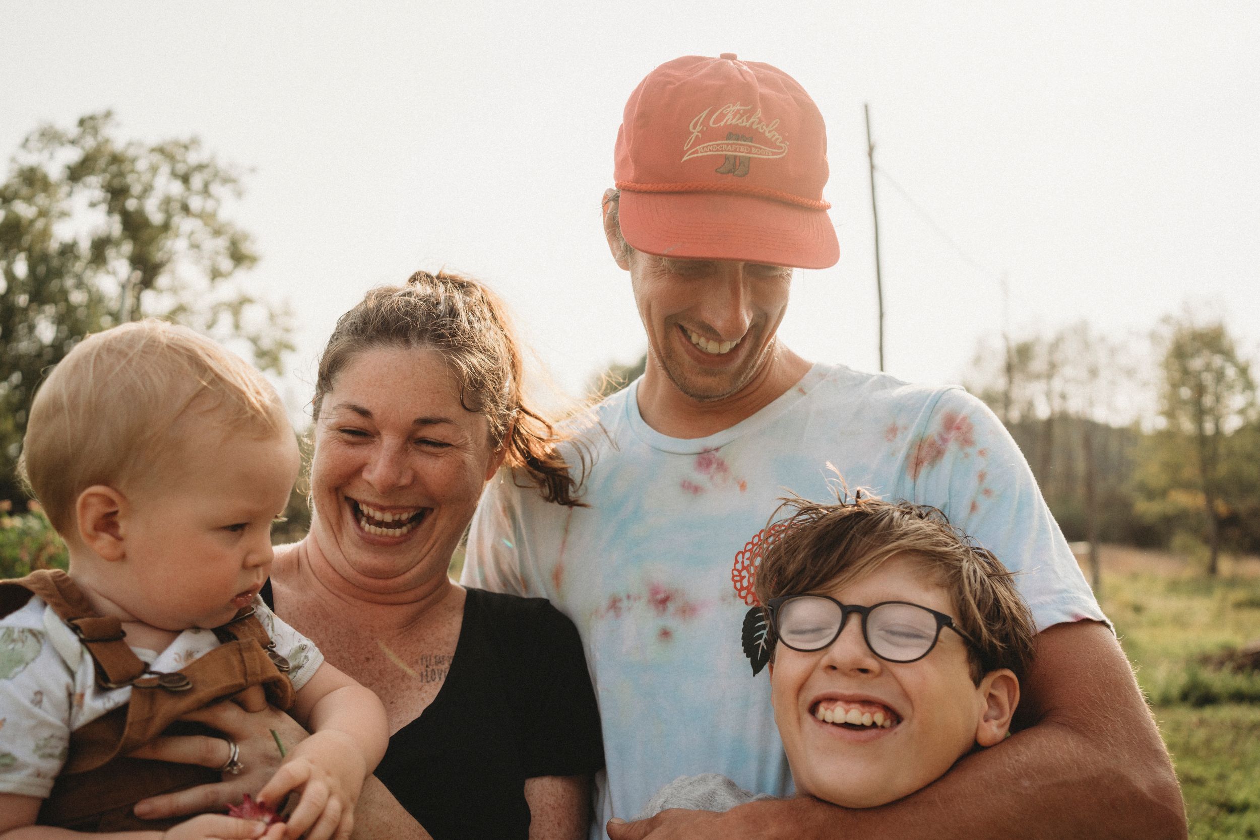 Happy family shares joyful moment together outdoors during golden hour.