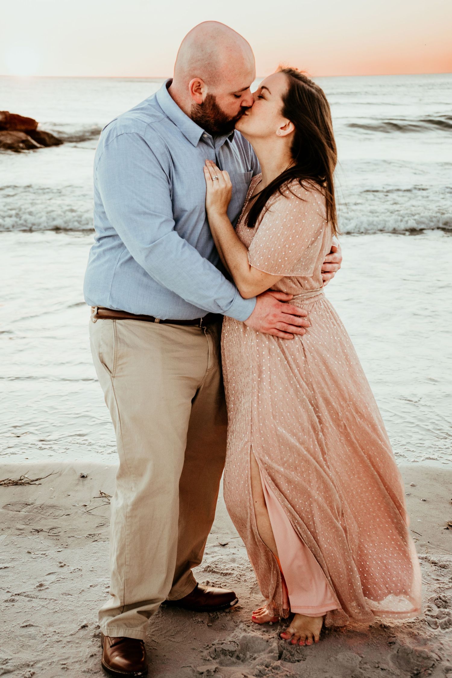 Engagement photo at sunset on Upham Beach in Pinellas County - couple kissing at sunset