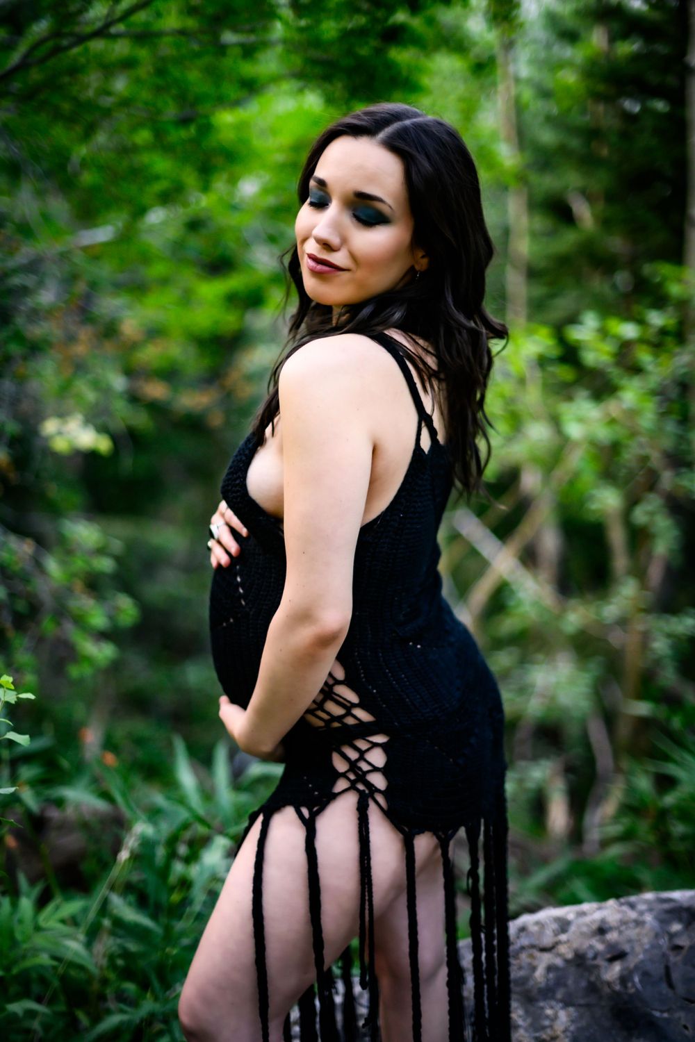Dramatic and moody maternity portrait against forest backdrop. Maternity photoshoot in Las Vegas. Maternity photographer Las Vegas.