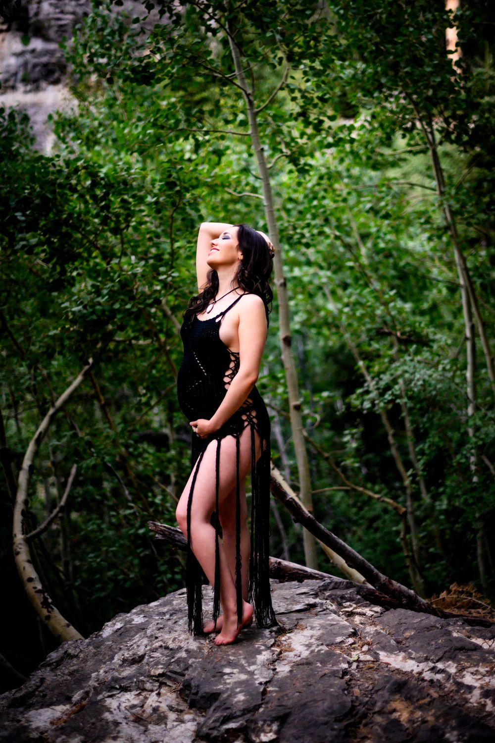 Dramatic forest portrait of pregnant woman surrounded by greenery. Maternity photoshoot in Las Vegas. Maternity photographer Las Vegas.