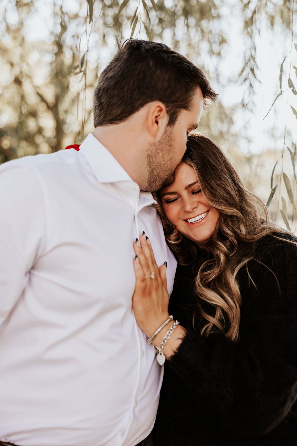 A tender moment shared between a couple after their engagement.