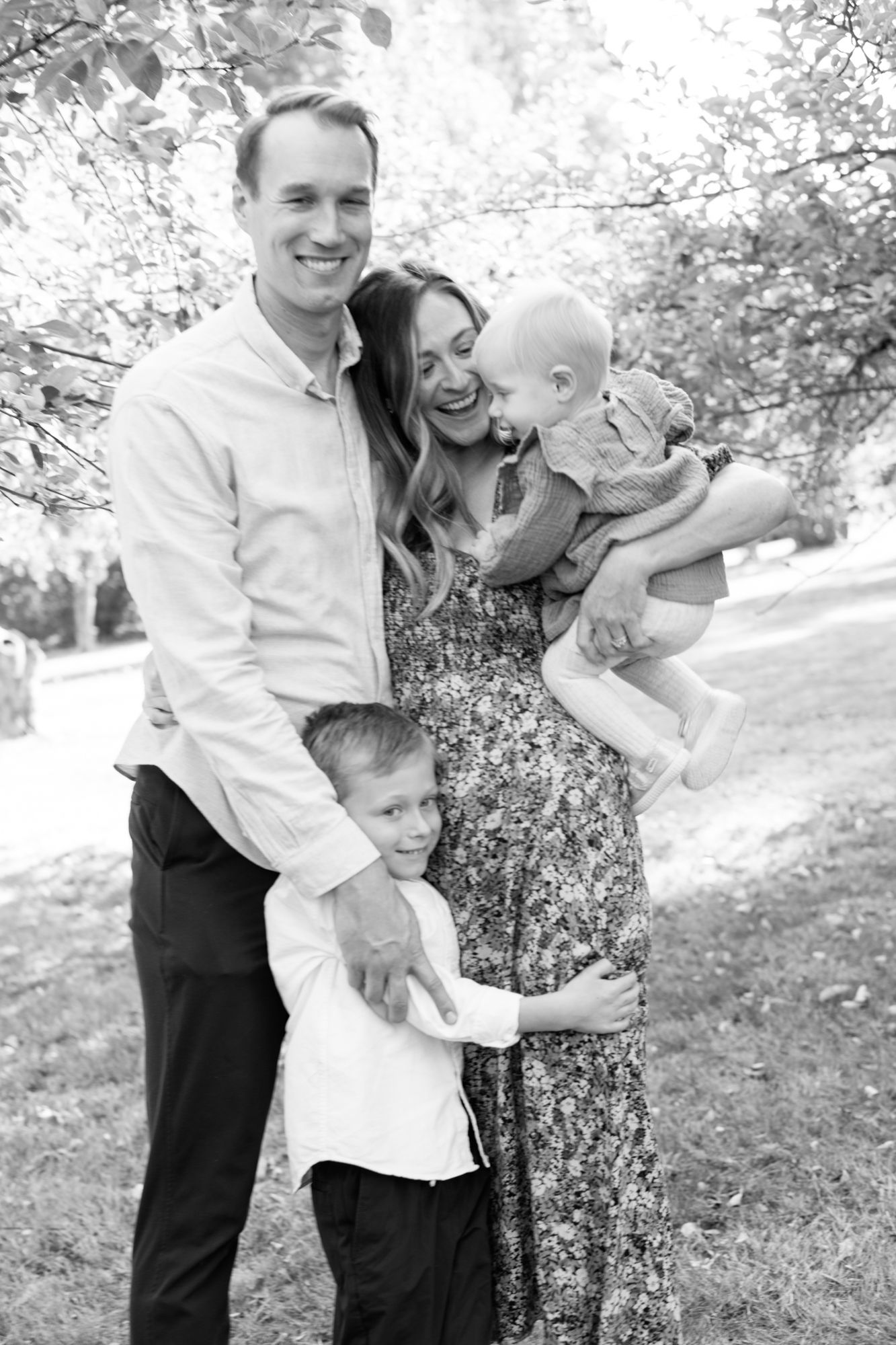 Outdoor black and white family portrait in spring setting.