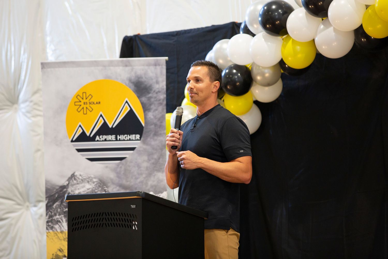 Corporate conference keynote speaker photographed on stage in Salt Lake City, Utah by professional event photographer