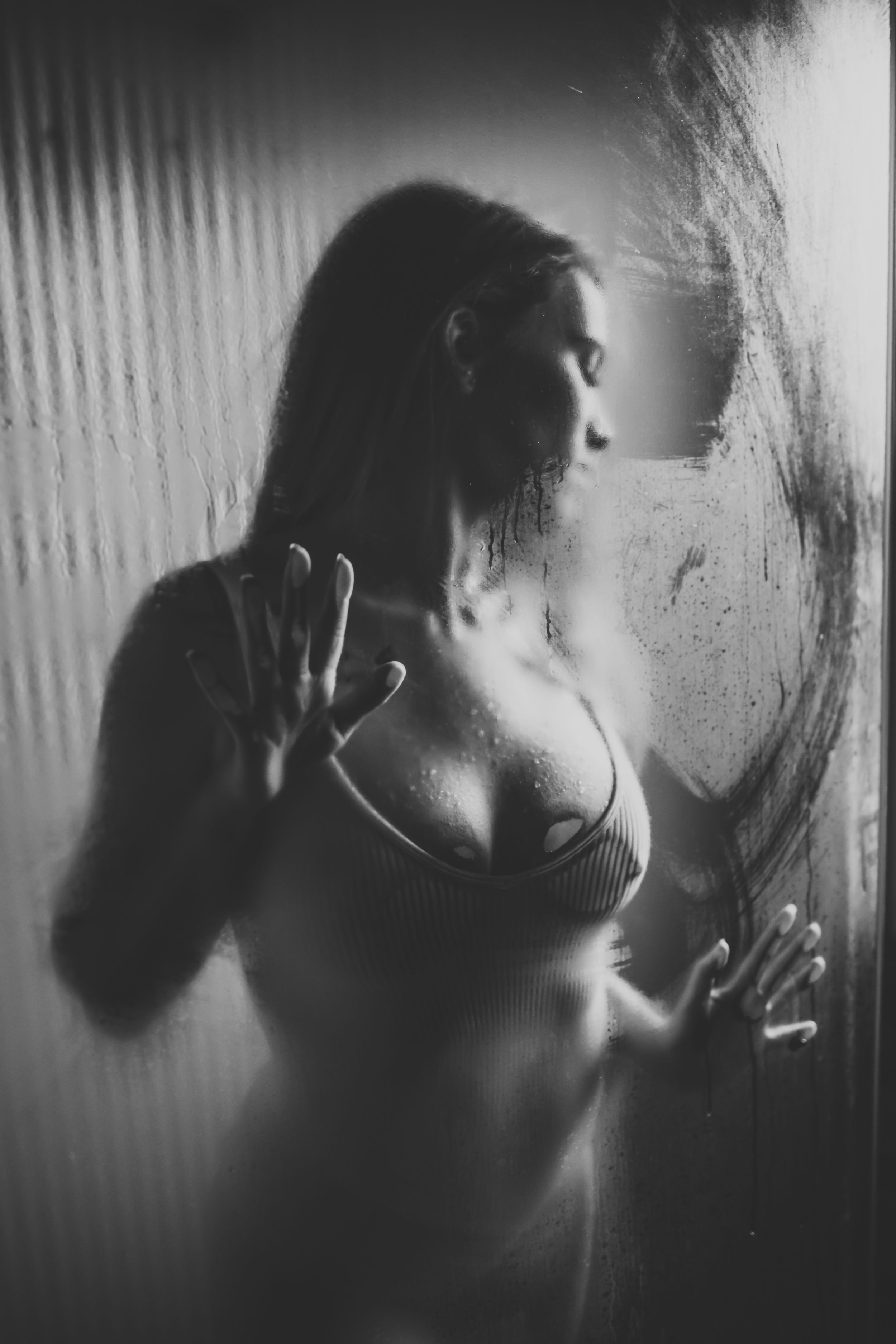 Black and white portrait series showing silhouetted figure against textured wall.