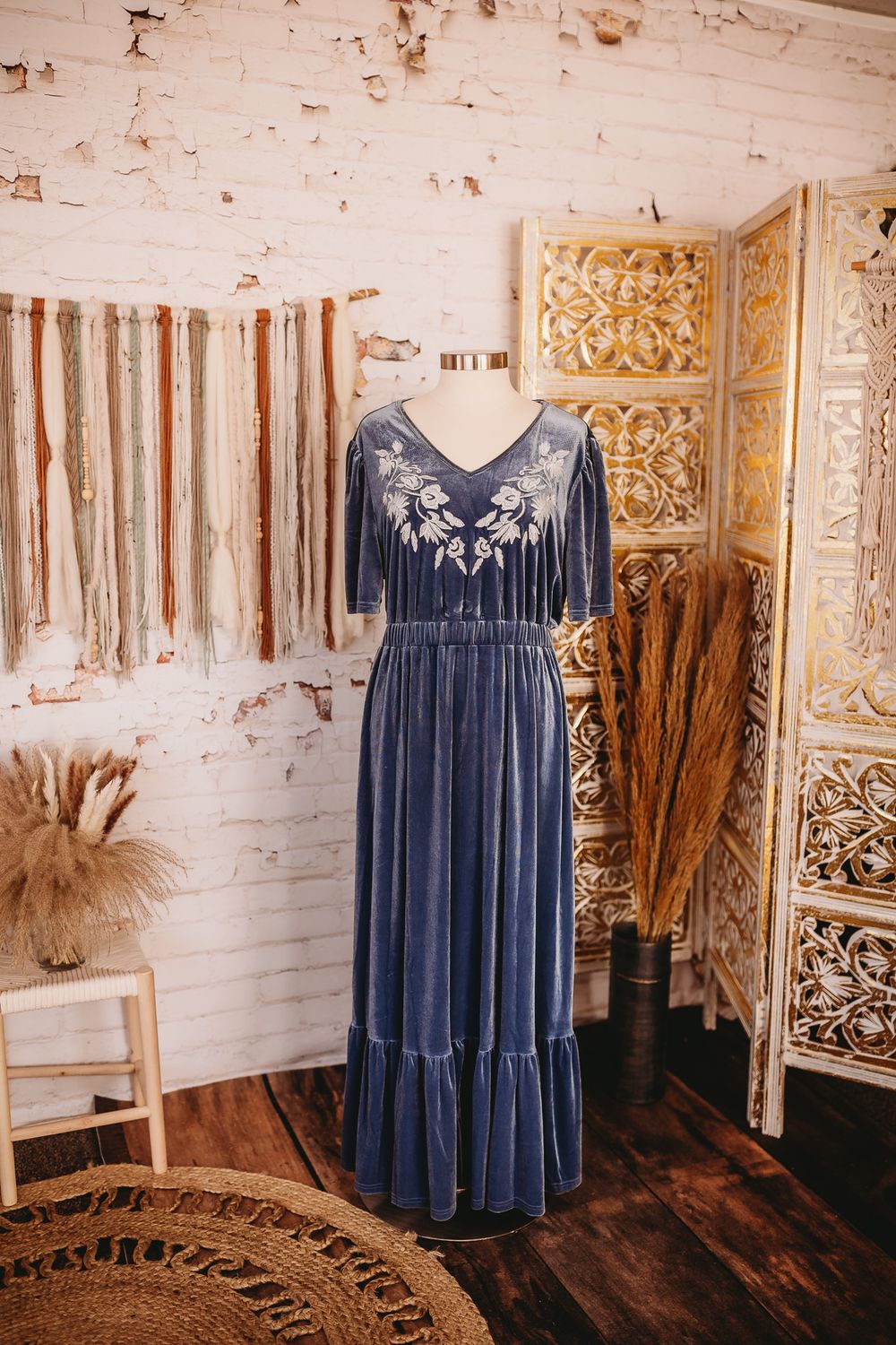 Steel blue velvet embroidered short sleeve tiered maxi dress on mannequin in boho boutique.