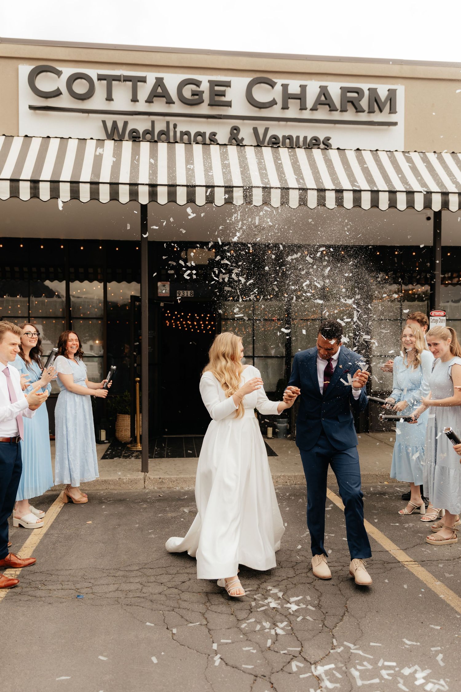 Bride and groom being hit with confetti canon during wedding exit