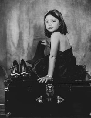 Dramatic black and white portraits captured on a vintage piano bench.