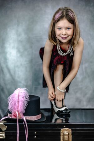 Stylish dance-inspired photo shoot with pink feather props on piano.