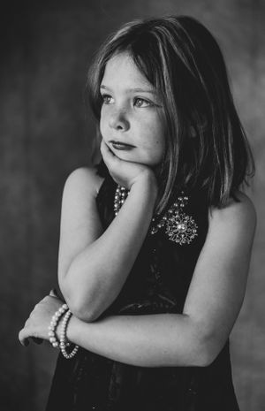 Monochrome portrait series showing contemplative poses with hand on chin.