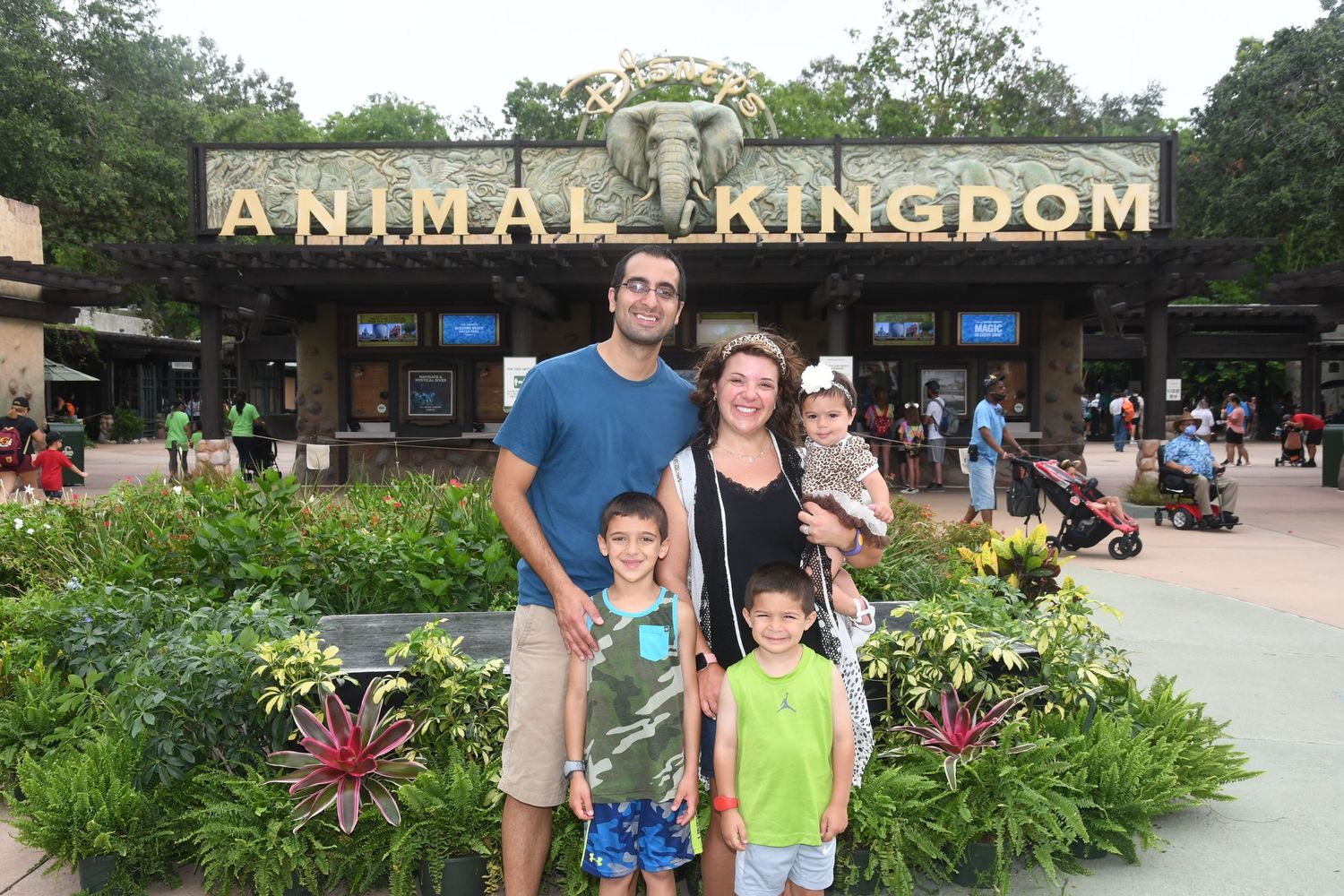 family standing in front of animal kingdom sign