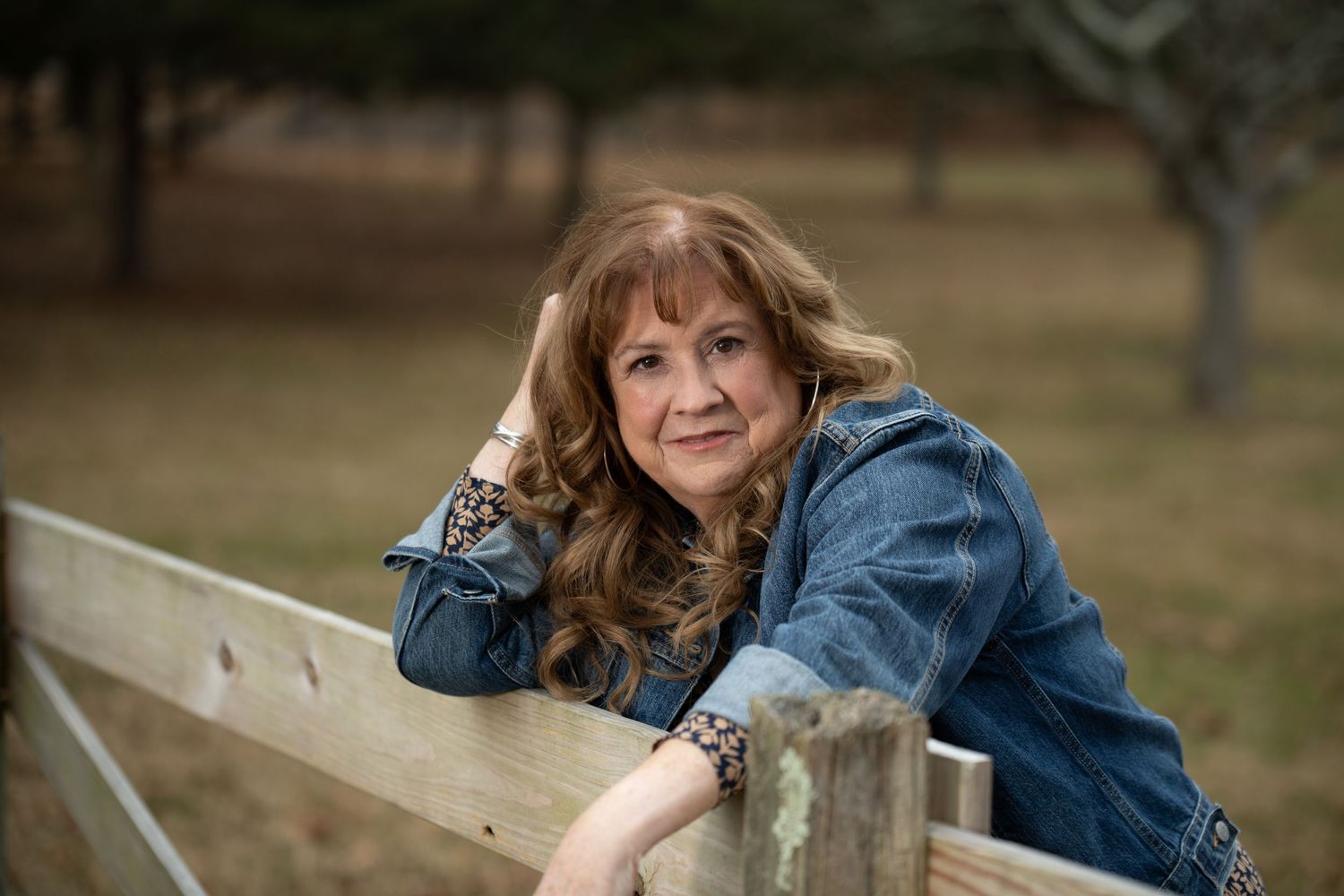 Outdoor portrait session showing casual denim jacket poses in natural setting.
