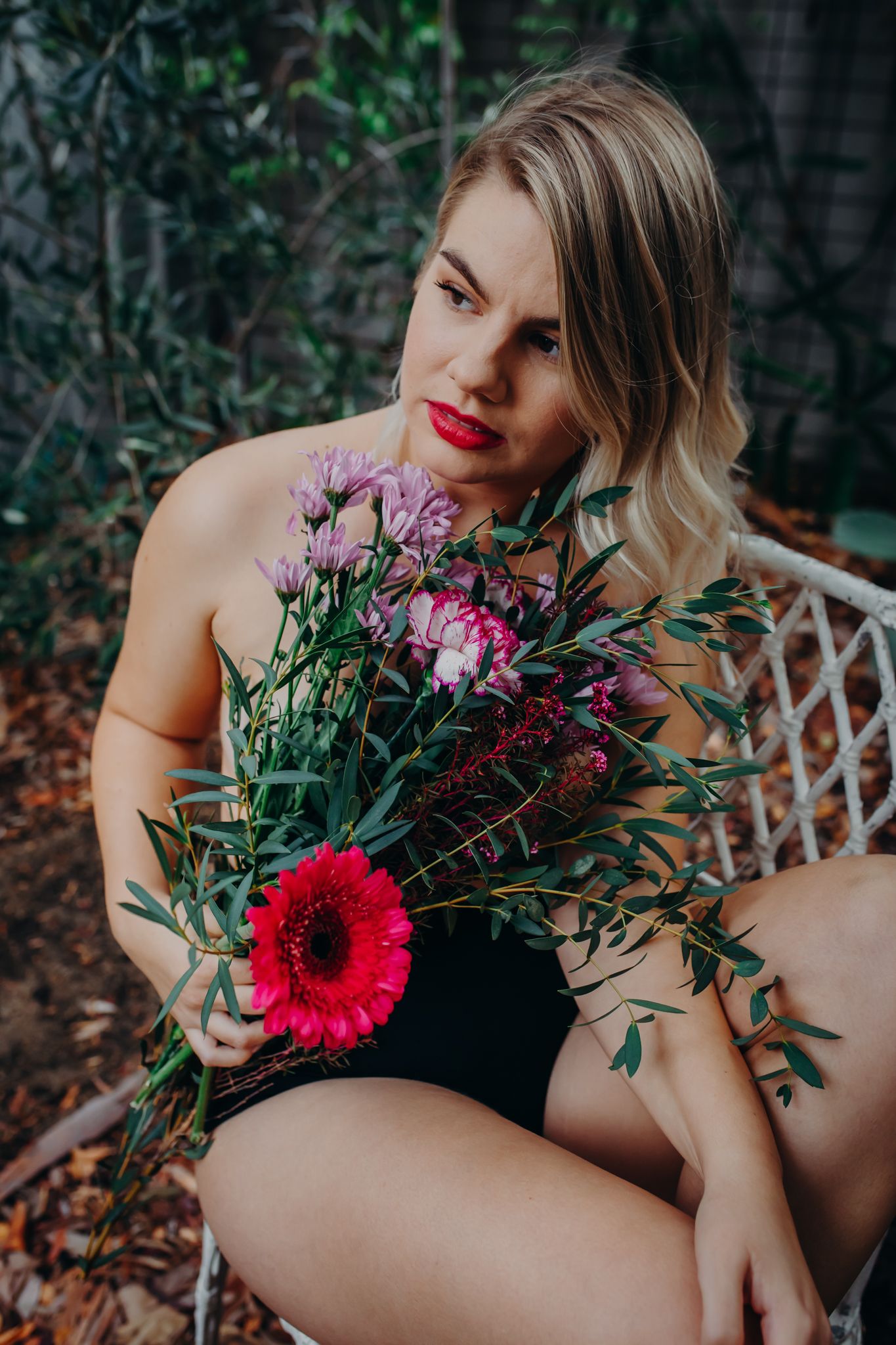 Intimate outdoor photo with colorful flower bouquet against natural garden backdrop.