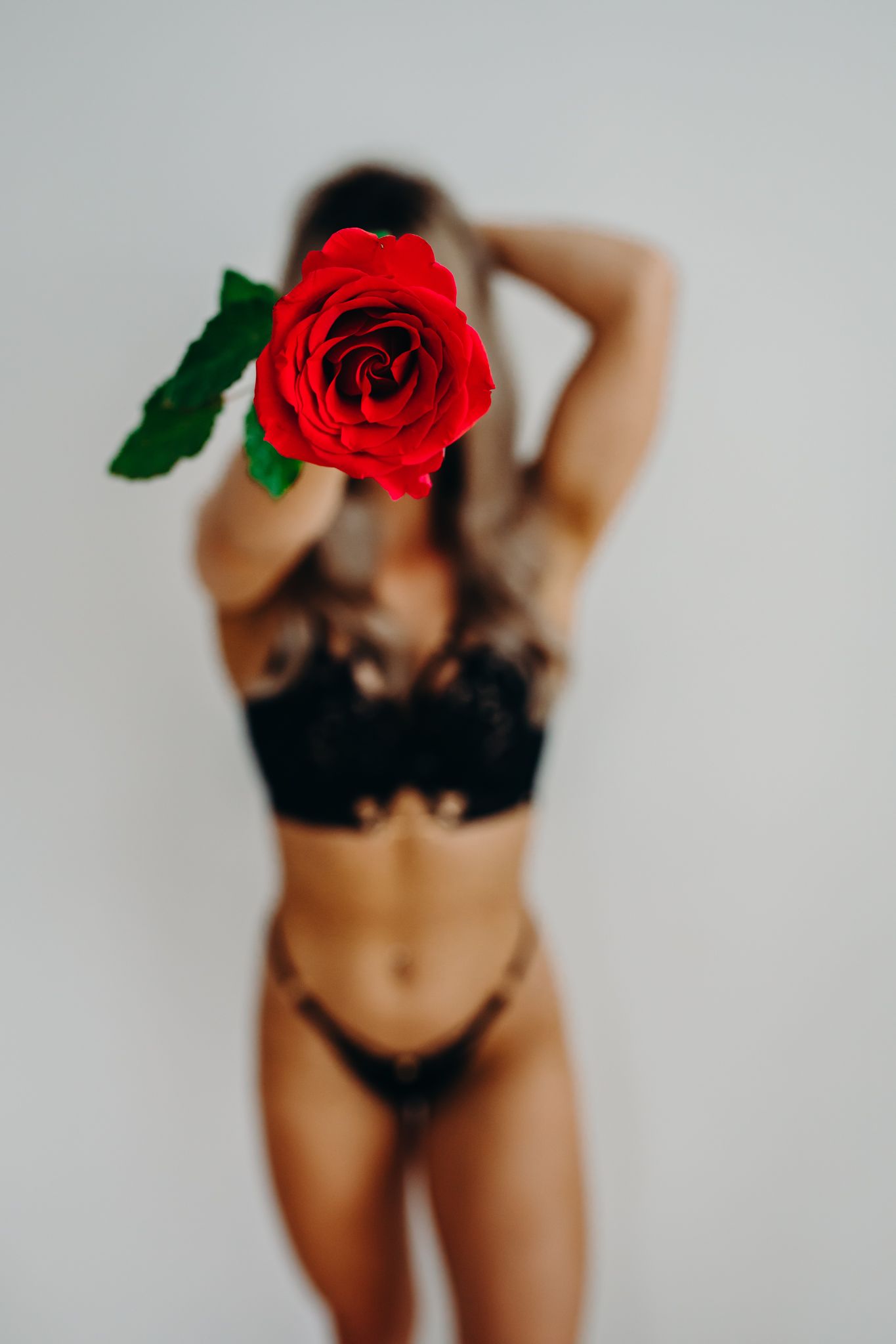 Artistic photo with bold red rose against white background.