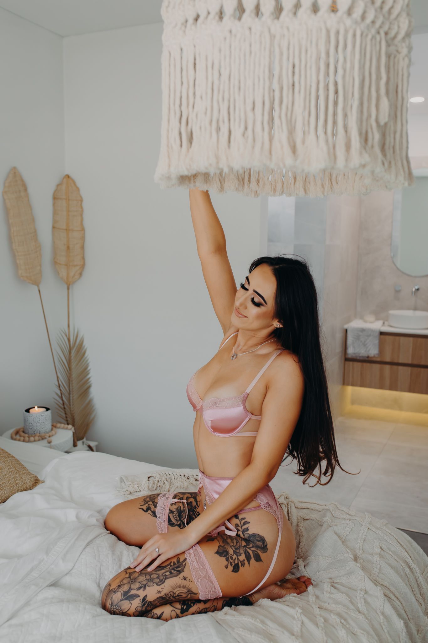 Bedroom interior with macrame wall hanging and pampas grass decor in a boho style setting.