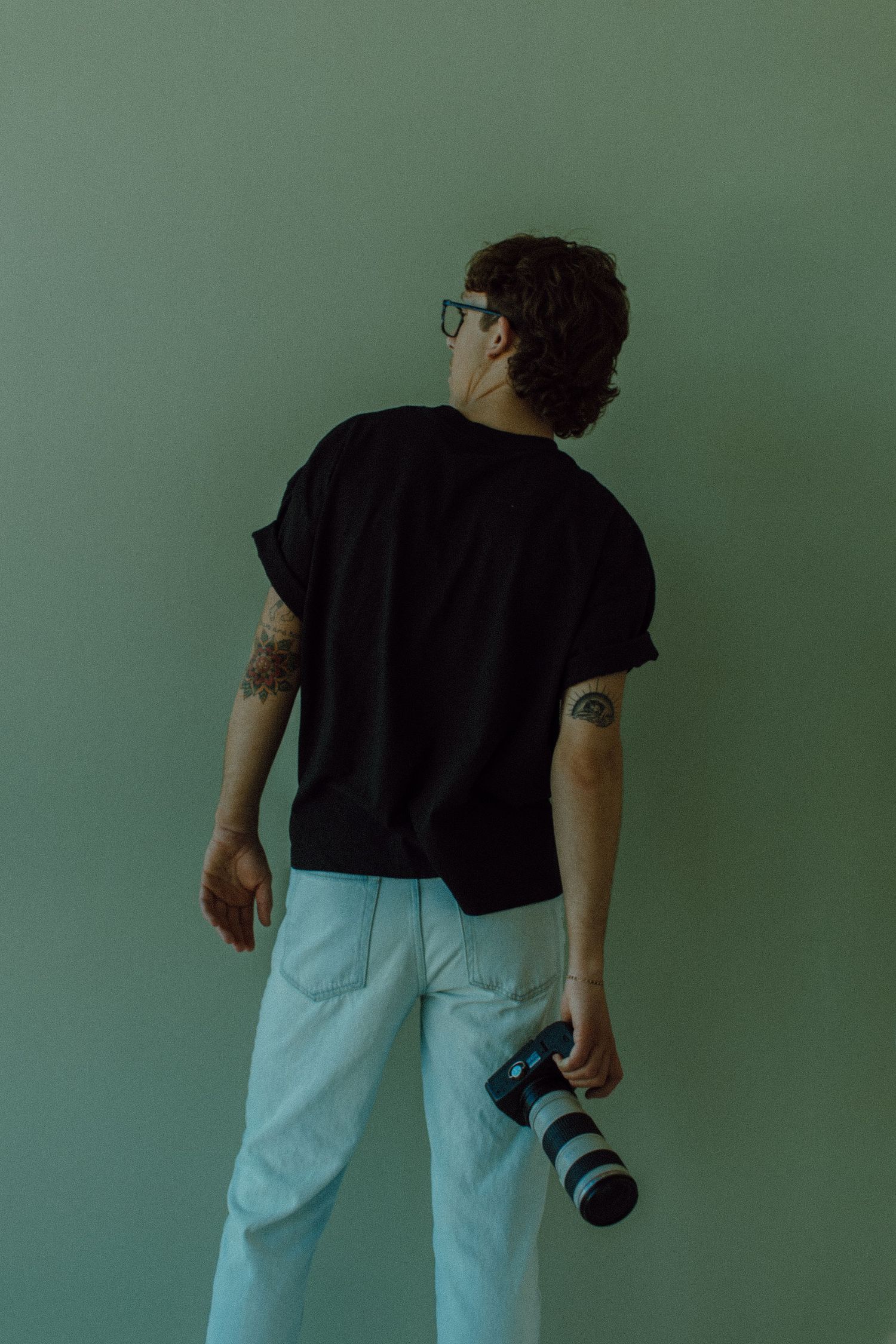 Gavin facing away from camera while holding his camera