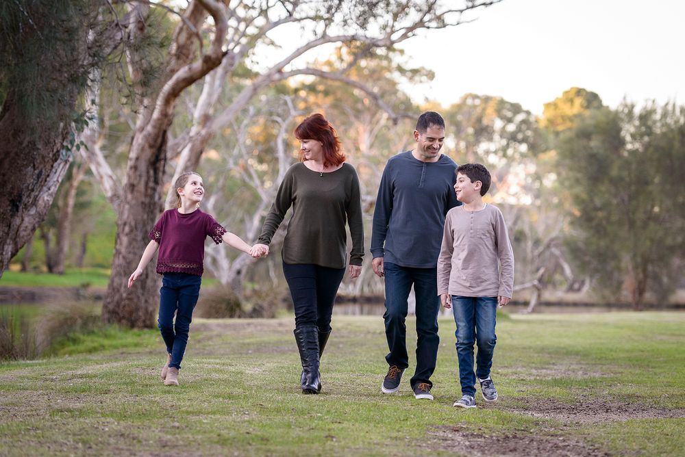 Family of four walking in a park - Kelly Chapman Photographer Perth