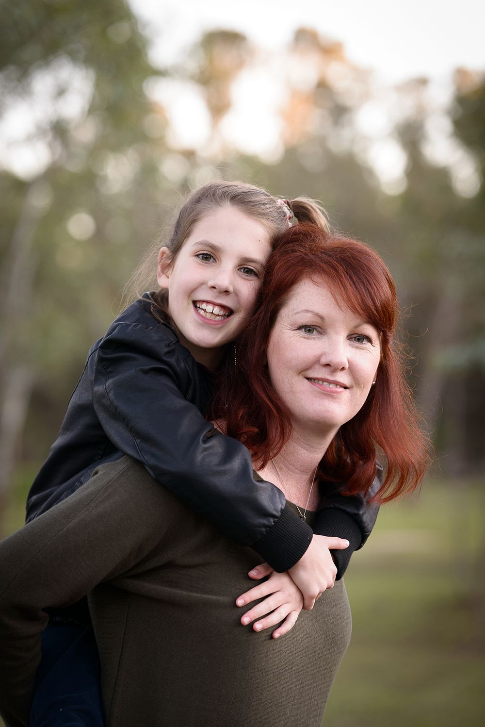 Mother piggy backing young daughter - Kelly Chapman Photographer Perth