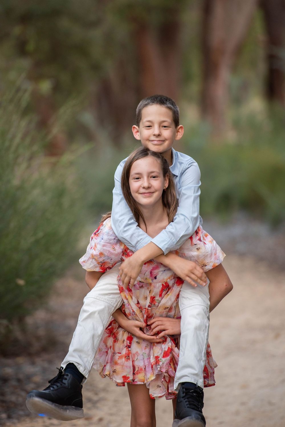 Young girl piggy backing brother - Kelly Chapman Photographer Perth