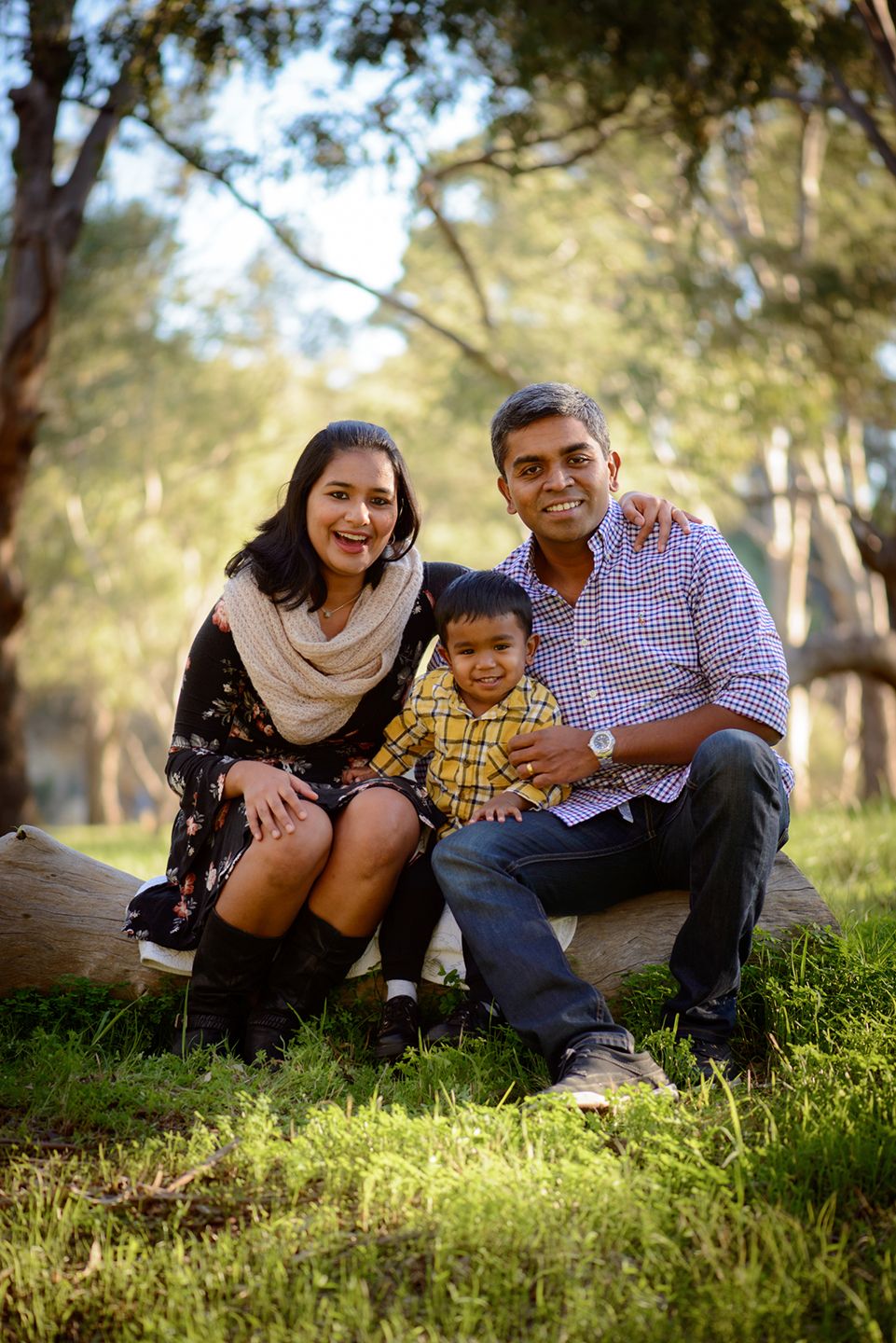 Family of three on a long in a park - Kelly Chapman Photographer Perth