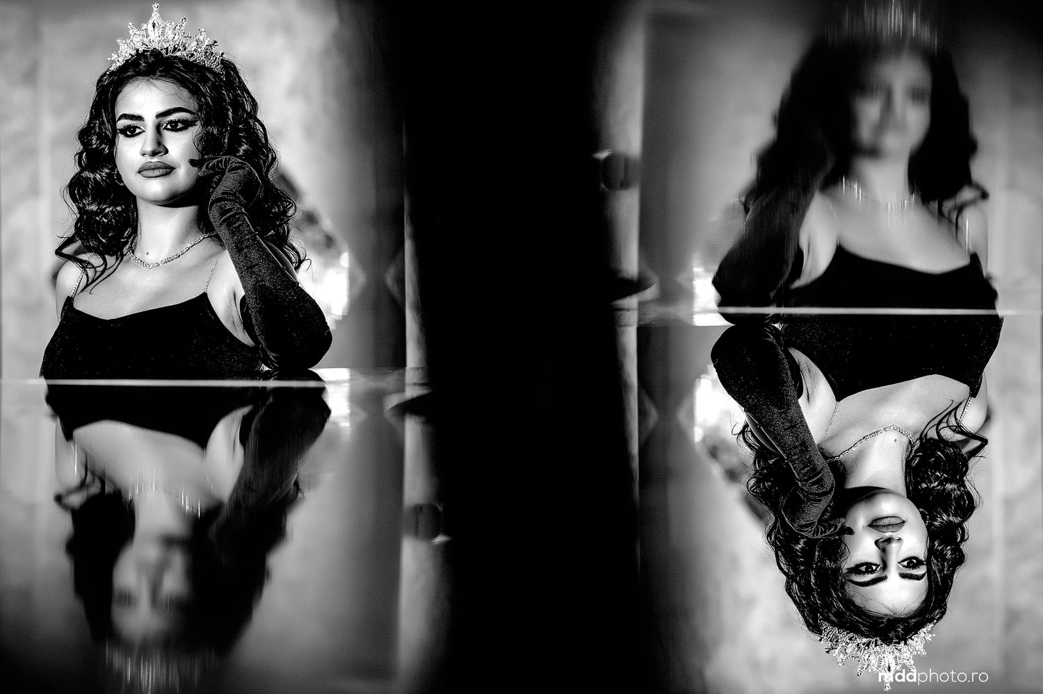 A black and white artistic portrait with mirror reflection effect showing a woman in dramatic lighting and elegant pose.