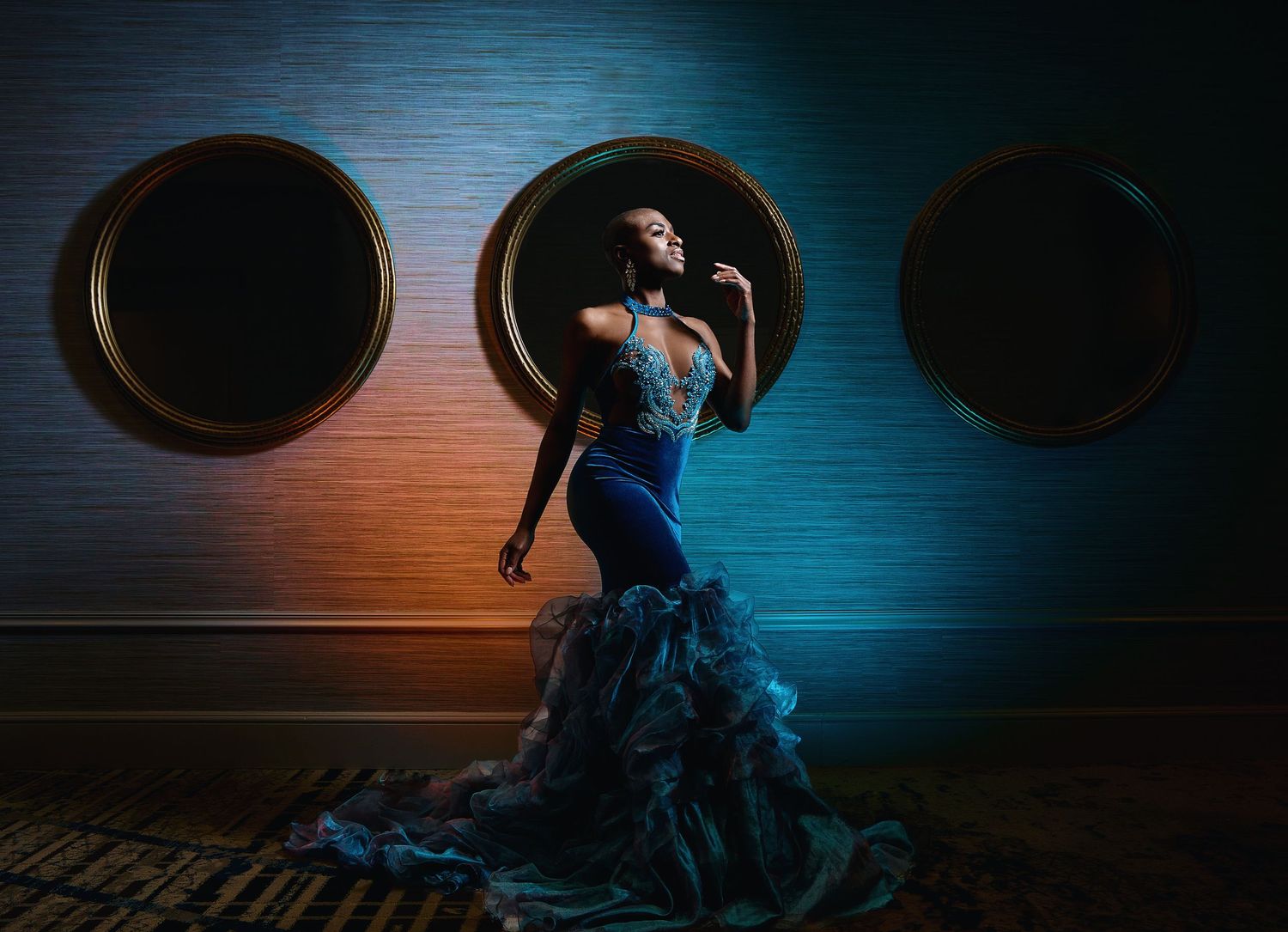 Artistic dance photography with blue lighting and silhouetted figure in motion.