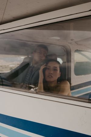 A romantic vintage-style photo session inside a small airplane with a retro aesthetic.
