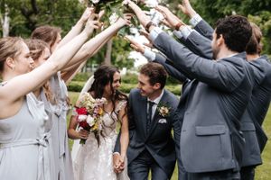 Wedding party and guests create a celebratory arch tunnel for the newlyweds. Photo at Charlottetown PE