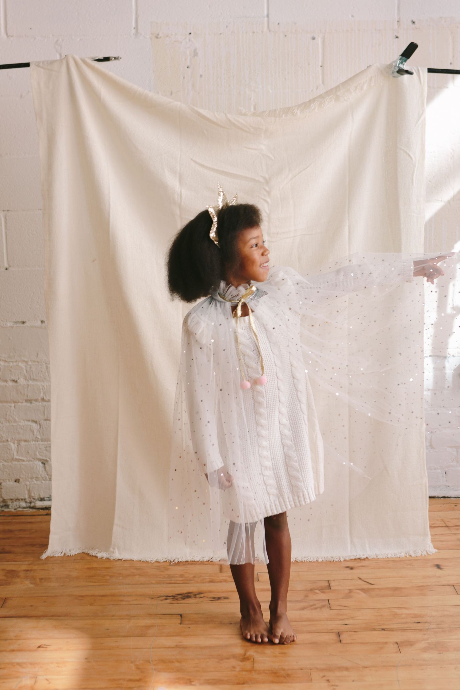 Family holding hands in festive outfits, captured by NYC family photographer Paula Brearley
