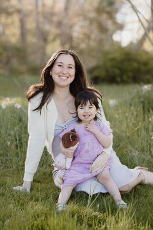 A springtime outdoor portrait with purple and white clothing in a meadow.