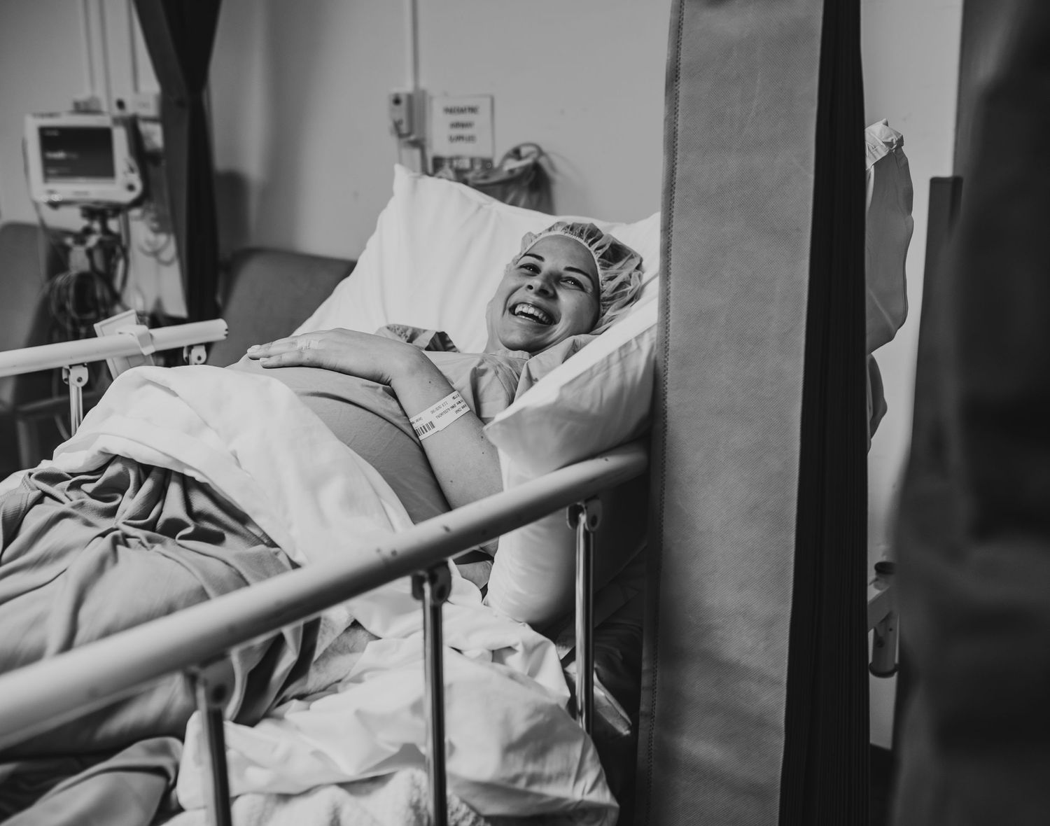 Black and white image of hospital room during medical procedure.
